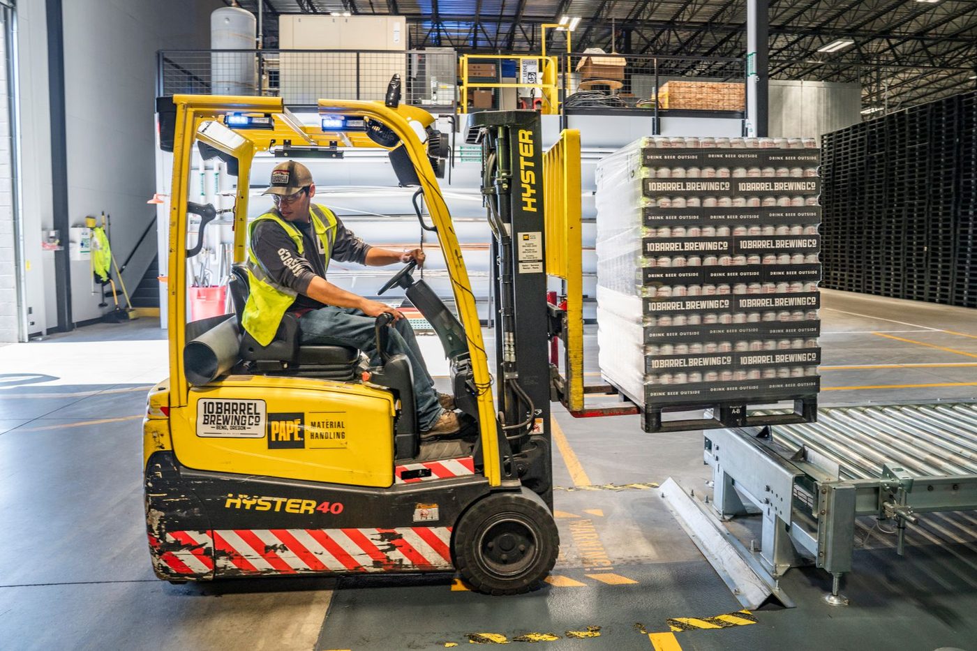 Forklift loading palletized freight for local tail-lift delivery
